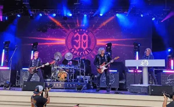 Vibrant concert performance by a band celebrating a 30th birthday with colorful stage lights and audience engagement.