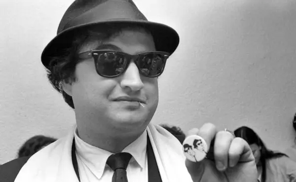 Person holding a button with a political icon.