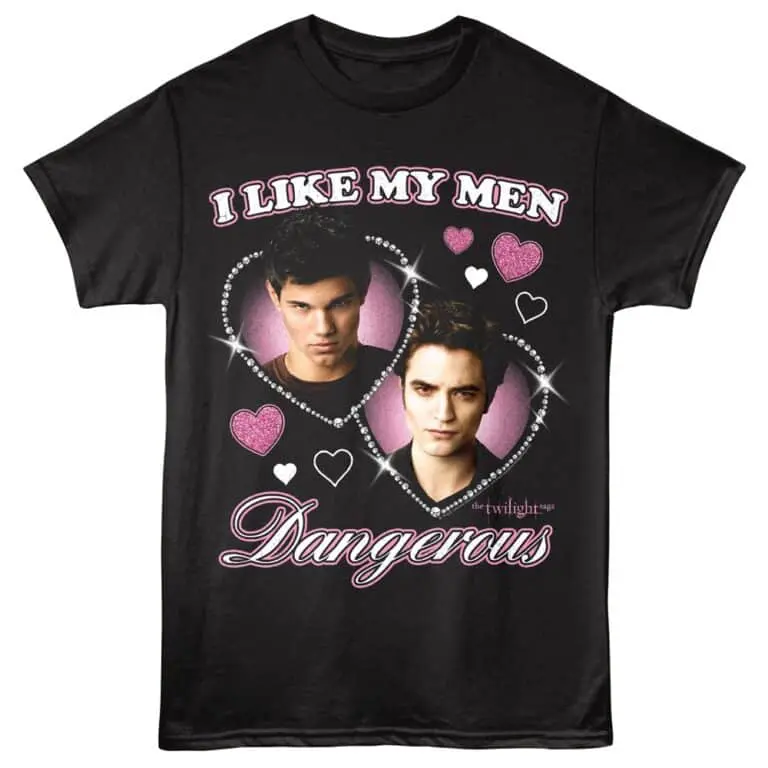 A black Twilight-themed T-shirt featuring two male characters surrounded by pink and white hearts, with bold "I LIKE MY MEN DANGEROUS" text.