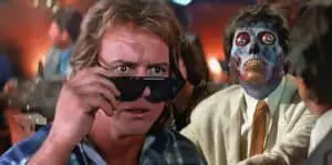 Eccentric characters in a movie scene featuring a man with sunglasses and a sinister masked figure.