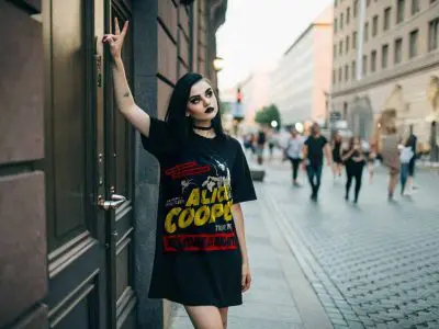 Bold goth girl fashion with dark makeup and graphic t-shirt on city street. Edgy streetwear style for alternative fashion enthusiasts.