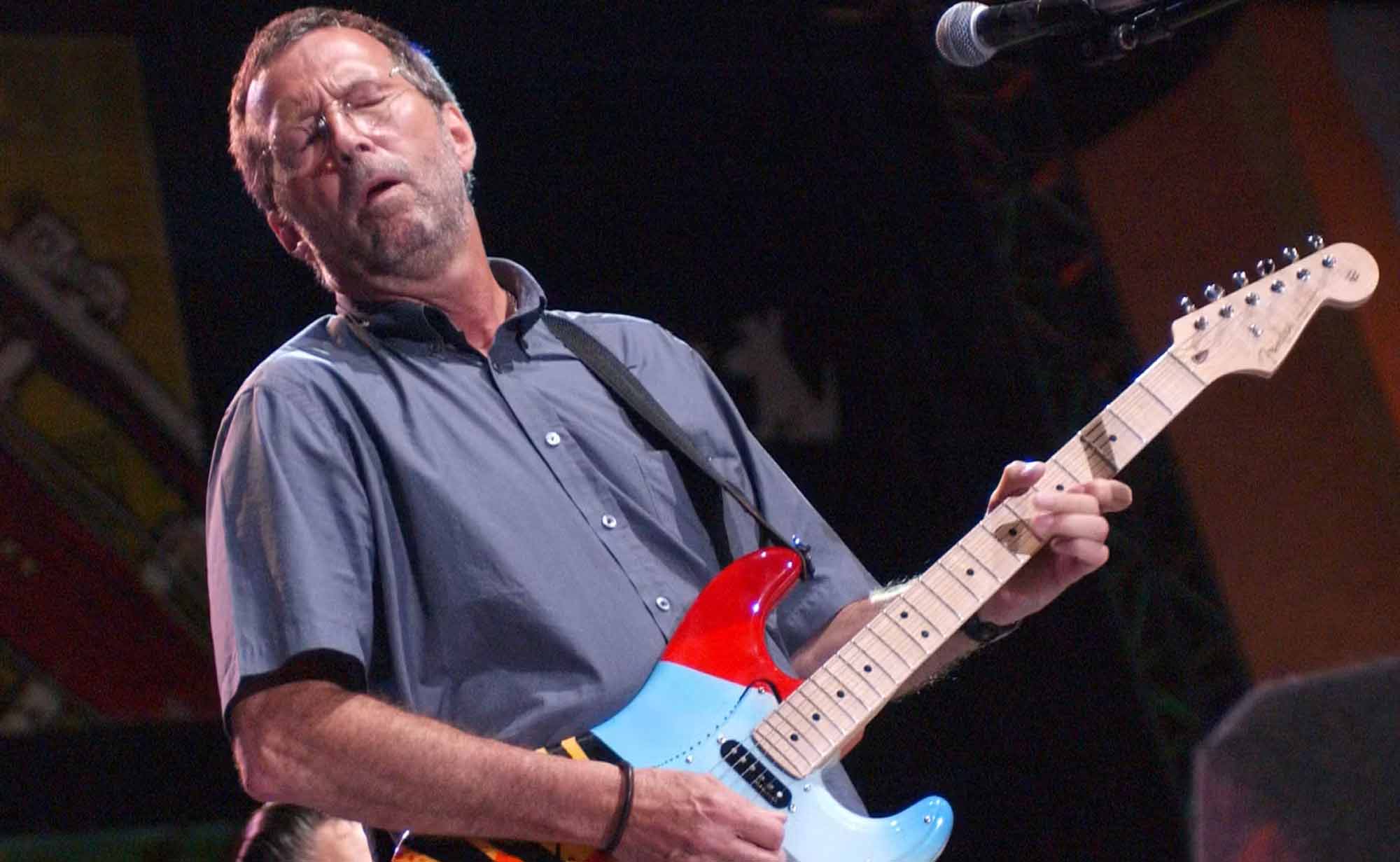 High-quality image of a musician playing electric guitar during a live concert.