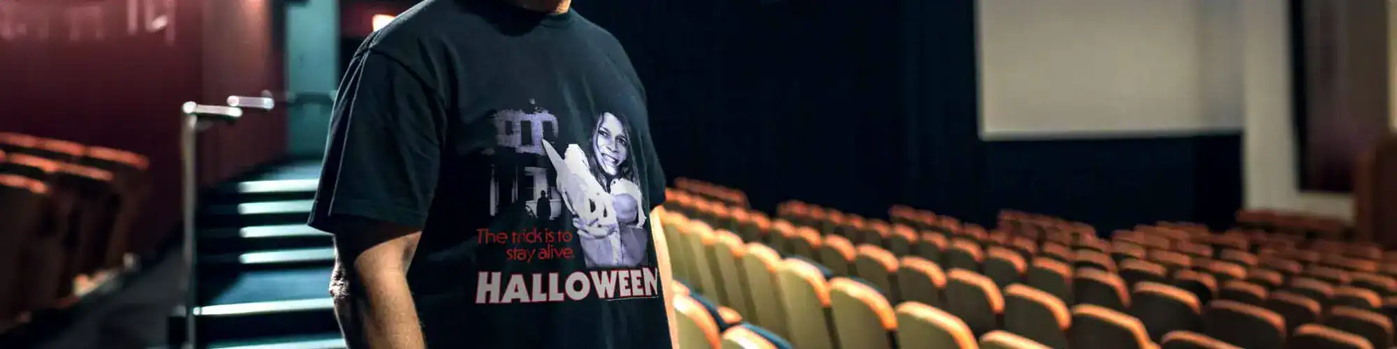 Halloween graphic tee featuring girl with spooky theme in cinema background.