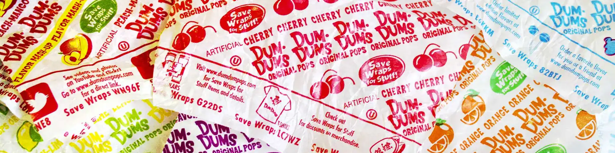 Colorful Dum Dums wrapped candies for kids and adults, featuring fruit flavors and vibrant packaging.