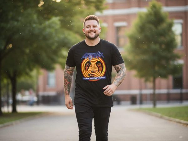 Vibrant man walking outdoors wearing a custom Anthrax "State of Euphoronia" band t-shirt, showcasing edgy style and musical passion in a lush park setting.