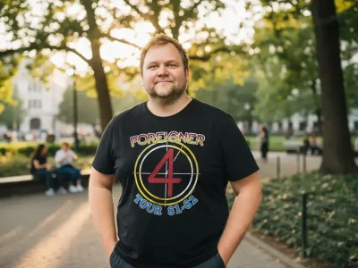 Man wearing Foreigner band tour t-shirt in park.