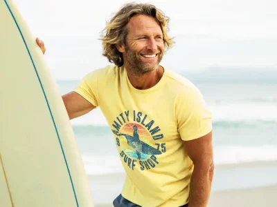 Men's casual yellow surf T-shirt with island and wave graphic for beach style.