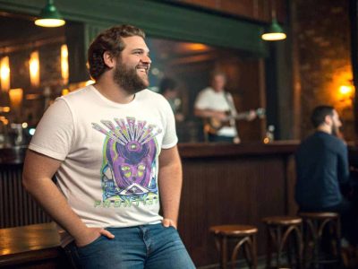Relaxed man in casual t-shirt enjoying live music at a cozy bar; vibrant nightlife, social atmosphere, and entertainment.