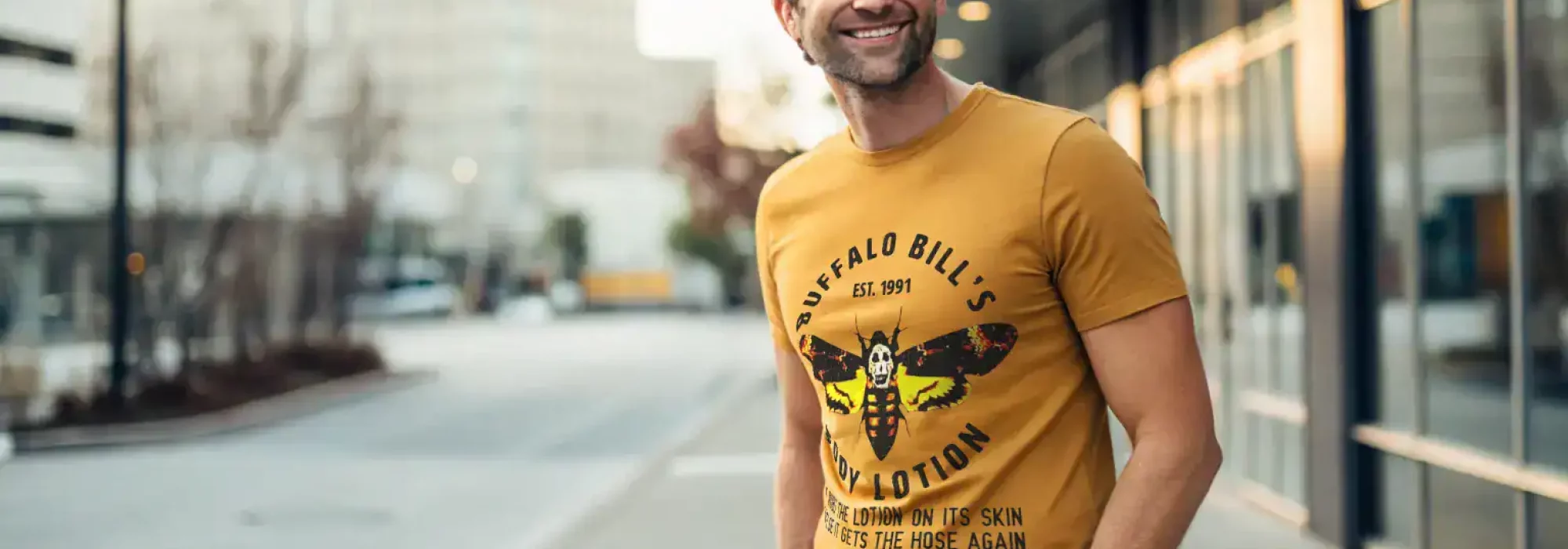 Men's yellow graphic t-shirt featuring Buffalo Bill's insect-themed illustration and humorous text.
