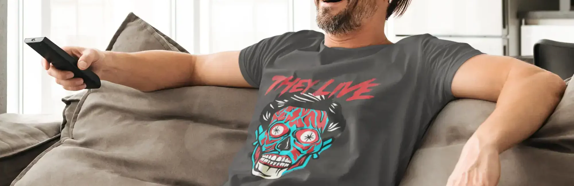 Smiling man in casual clothes relaxing on sofa, holding remote, enjoying leisure time at home.