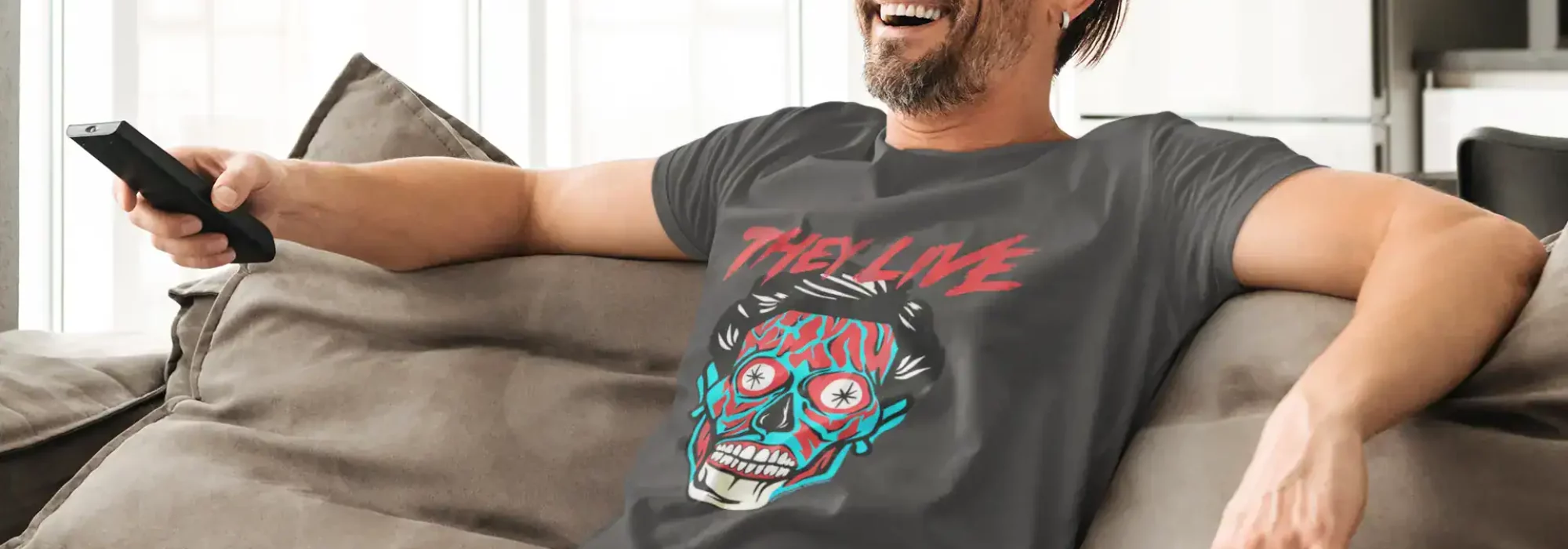 Smiling man in casual clothes relaxing on sofa, holding remote, enjoying leisure time at home.