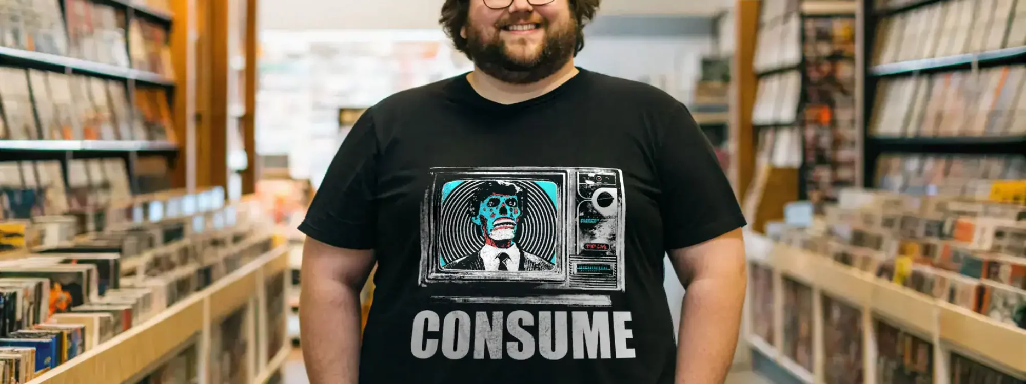 Men's pop culture T-shirt featuring skeleton TV graphic and "Consume" slogan, ideal for trendy fashion.