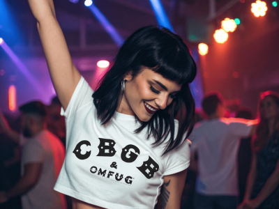 Young woman dancing at a vibrant nightclub, wearing a CBGB OMFG logo t-shirt, with colorful lights creating an energetic party atmosphere.