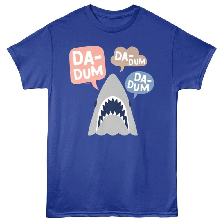 Bright blue T-shirt featuring a cartoon shark with speech bubbles saying "DADUM" for fun, trendy apparel.