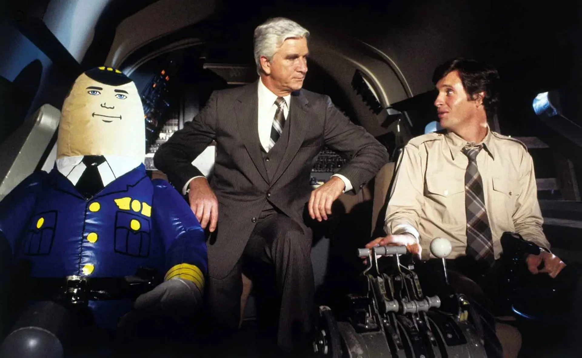 A comical "Captain" character in a blue uniform and a pilot in a spacecraft cockpit.
